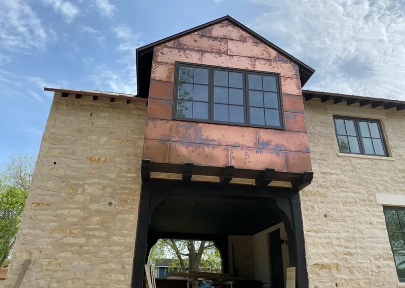 Copper metal panel facade on a stone building for Roof Repair in Rockmart